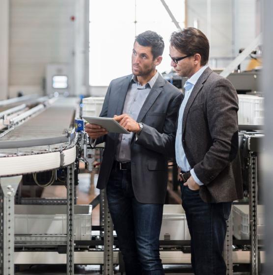 Two men inspect an automation facility